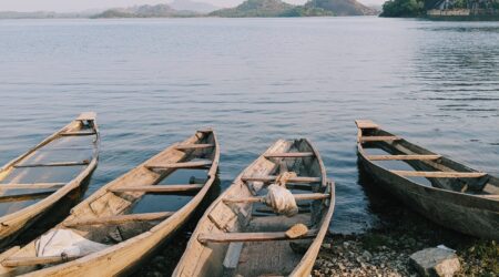 canoes river mountain sky