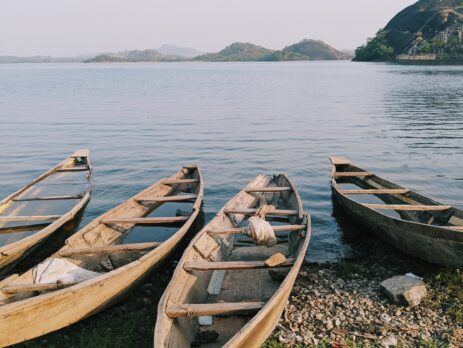 canoes river mountain sky